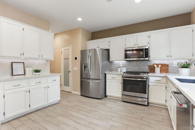 339 Alamo Way, Oceanside, CA 92057 - kitchen with stainless steel appliances, white cabinetry, tasteful backsplash, light countertops, and recessed lighting