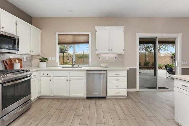 339 Alamo Way, Oceanside, CA 92057 - kitchen featuring appliances with stainless steel finishes, light countertops, light wood-style flooring, and white cabinetry