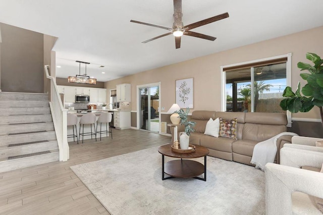 339 Alamo Way, Oceanside, CA 92057 - living room with light wood finished floors, ceiling fan, stairs, and recessed lighting