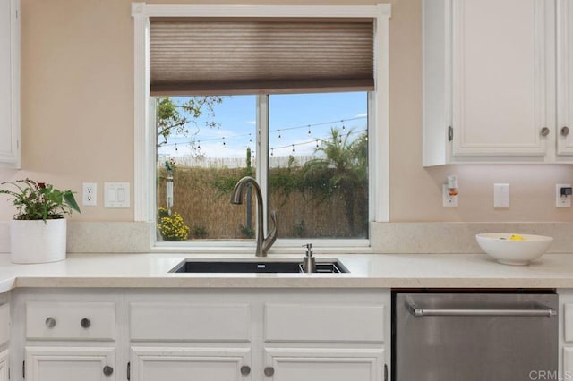 339 Alamo Way, Oceanside, CA 92057 - kitchen with dishwasher, white cabinets, and light countertops