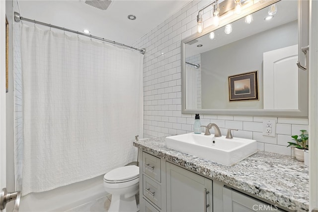 18 El Cerrito Dr, Chico, CA 95973 - bathroom featuring tile walls, vanity, tasteful backsplash, shower / tub combo, and recessed lighting