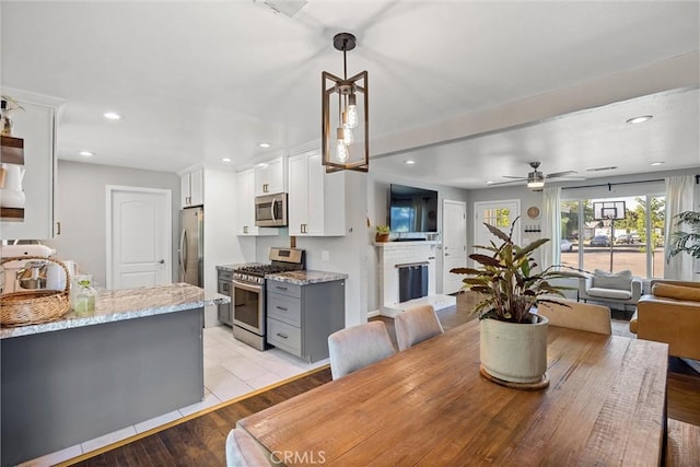 18 El Cerrito Dr, Chico, CA 95973 - dining room with ceiling fan, recessed lighting, a brick fireplace, and light wood-type flooring