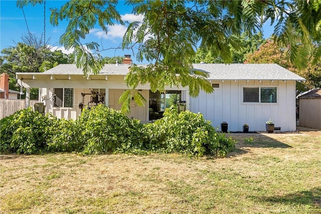 18 El Cerrito Dr, Chico, CA 95973 - view of front of property featuring board and batten siding, a chimney, and a shingled roof