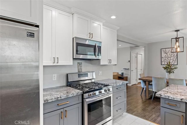 18 El Cerrito Dr, Chico, CA 95973 - kitchen featuring appliances with stainless steel finishes, gray cabinets, light stone countertops, decorative light fixtures, and recessed lighting