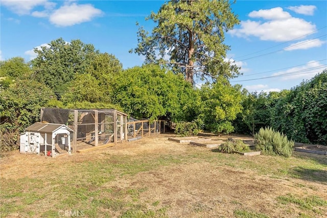 18 El Cerrito Dr, Chico, CA 95973 - view of green lawn with a garden, exterior structure, and an outdoor structure