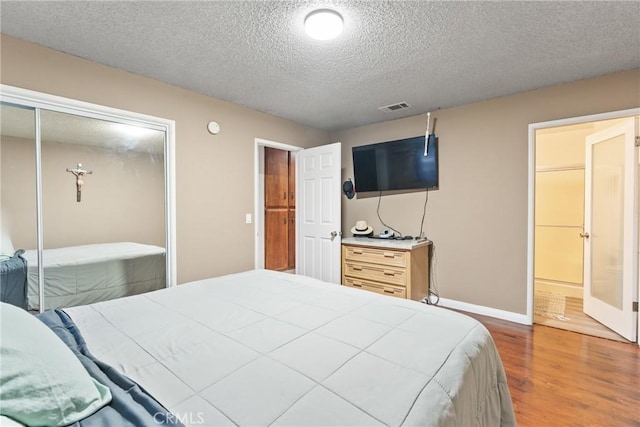 5983 Jones Ave, Riverside, CA 92505 - bedroom with wood finished floors, a textured ceiling, and a closet