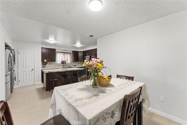 5983 Jones Ave, Riverside, CA 92505 - dining space featuring light tile patterned flooring and a textured ceiling
