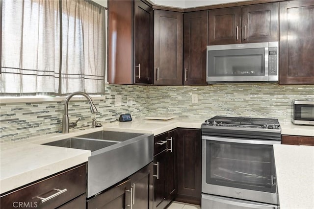 5983 Jones Ave, Riverside, CA 92505 - kitchen featuring stainless steel appliances, light countertops, dark brown cabinets, and decorative backsplash