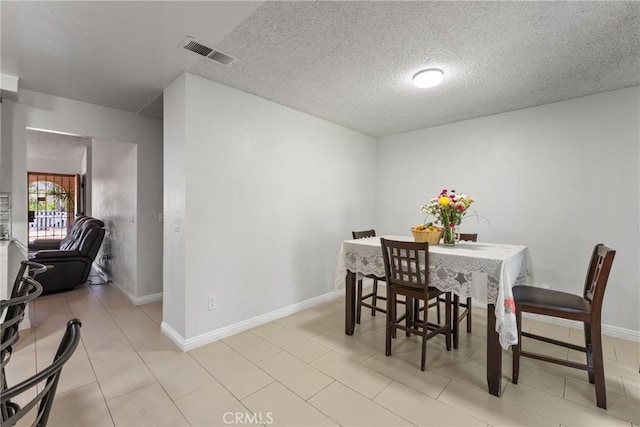 5983 Jones Ave, Riverside, CA 92505 - dining area with a textured ceiling and light tile patterned floors