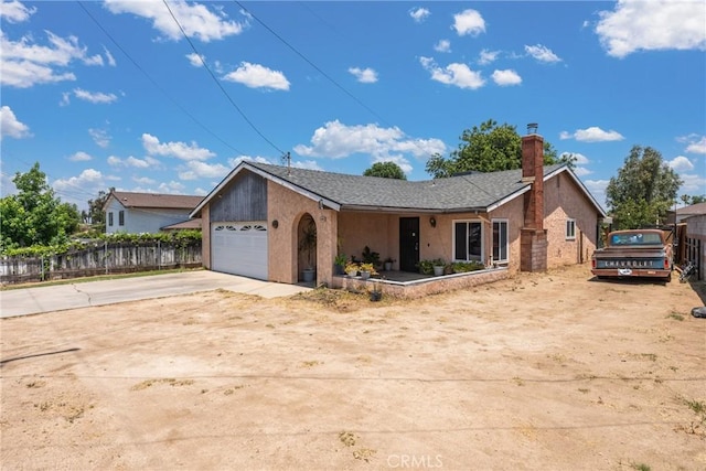 5983 Jones Ave, Riverside, CA 92505 - ranch-style house featuring concrete driveway, a chimney, an attached garage, and stucco siding