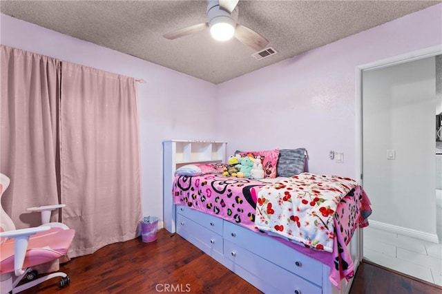 5983 Jones Ave, Riverside, CA 92505 - bedroom featuring dark wood-type flooring, a textured ceiling, and ceiling fan