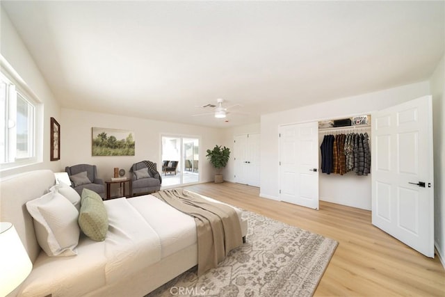 40911 Lela May Ave, Hemet, CA 92544 - bedroom with light wood-type flooring, multiple closets, and ceiling fan