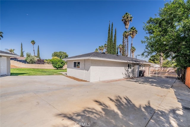 40911 Lela May Ave, Hemet, CA 92544 - view of side of home featuring stucco siding, a patio, and a fenced backyard