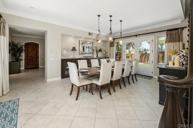 13388 Greenstone Ct, Scripps Miramar, CA 92131 - dining area with french doors, light tile patterned floors, ornamental molding, and arched walkways