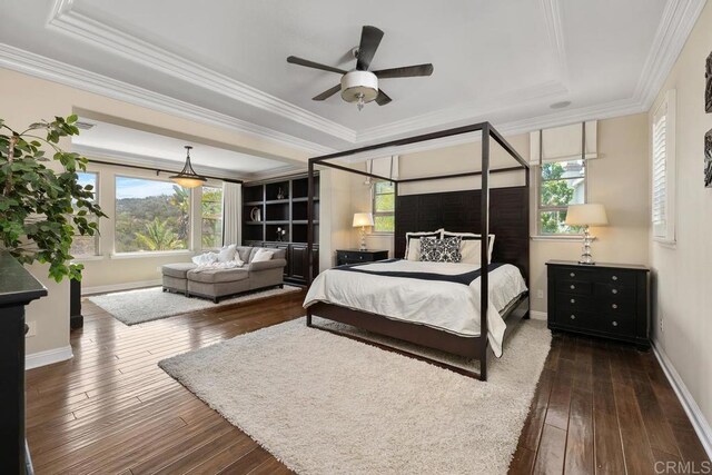 13388 Greenstone Ct, Scripps Miramar, CA 92131 - bedroom featuring a raised ceiling, dark wood-style flooring, multiple windows, and ornamental molding