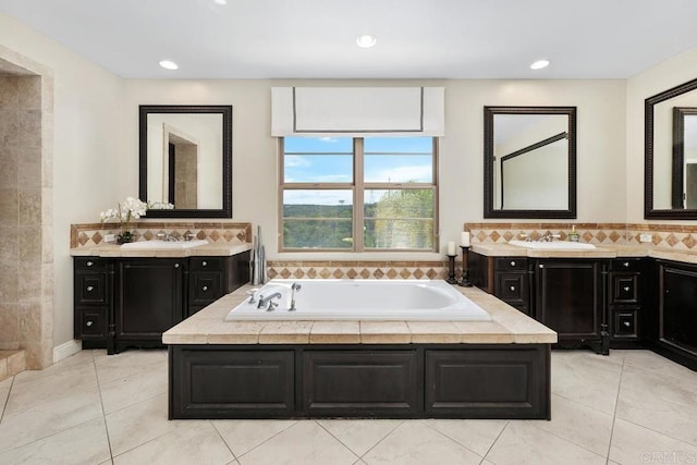 13388 Greenstone Ct, Scripps Miramar, CA 92131 - bathroom featuring a bath, two vanities, tile patterned floors, and recessed lighting