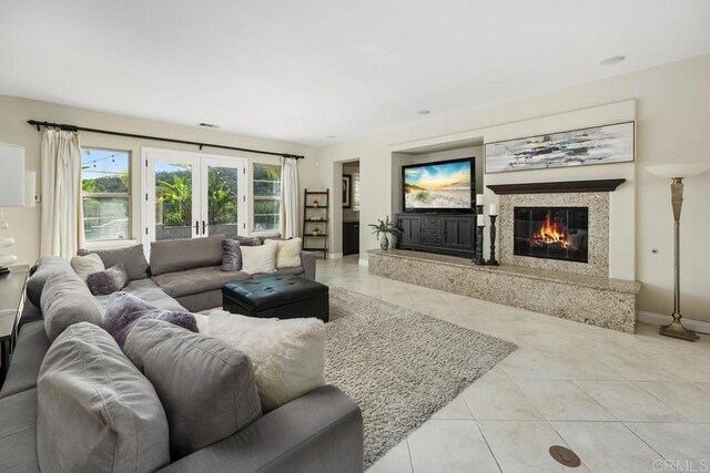 13388 Greenstone Ct, Scripps Miramar, CA 92131 - tiled living room with a high end fireplace and french doors