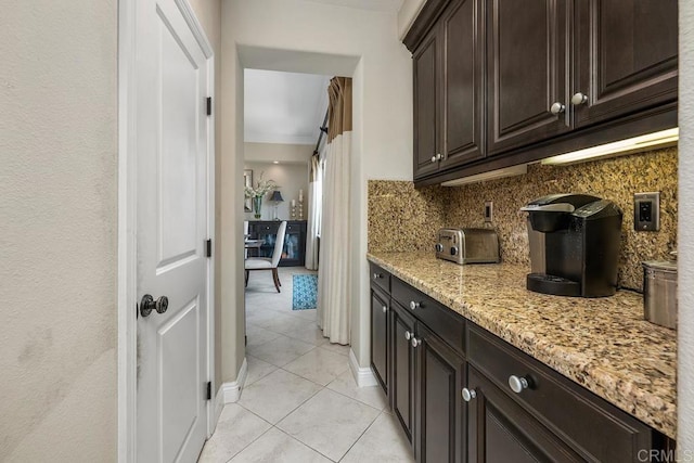 13388 Greenstone Ct, Scripps Miramar, CA 92131 - kitchen with light tile patterned floors, backsplash, light stone counters, and dark brown cabinetry