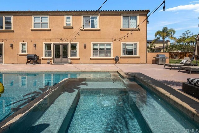 13388 Greenstone Ct, Scripps Miramar, CA 92131 - back of property featuring french doors, stucco siding, and a patio