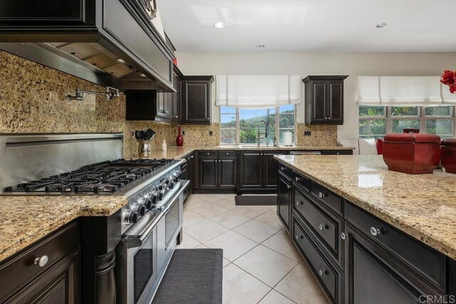 13388 Greenstone Ct, Scripps Miramar, CA 92131 - kitchen featuring range with two ovens, tasteful backsplash, light tile patterned floors, custom range hood, and recessed lighting
