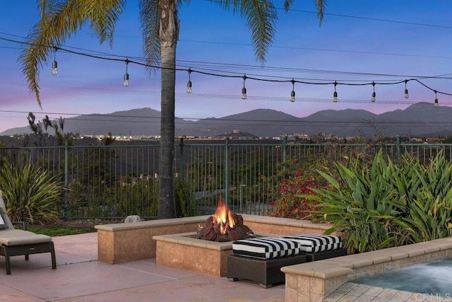 13388 Greenstone Ct, Scripps Miramar, CA 92131 - patio terrace at dusk with a fire pit, a mountain view, and a patio