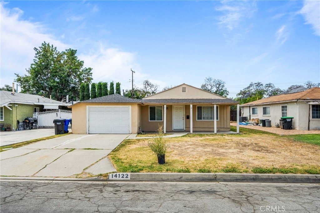 14122 Reis St, Whittier, CA 90604 - view of front of home featuring an attached garage, concrete driveway, stucco siding, and covered porch