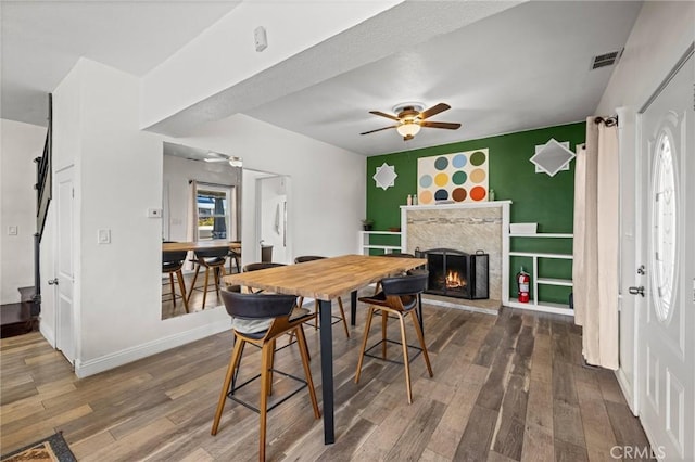 3144 Vista Ave, Lemon Grove, CA 91945 - dining space with ceiling fan, an accent wall, wood-type flooring, and a premium fireplace