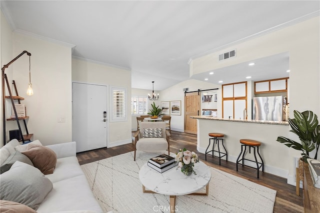 55 Rabano Unit 240, Rancho Santa Margarita, CA 92688 - living room featuring a barn door, ornamental molding, a chandelier, dark wood-style floors, and recessed lighting