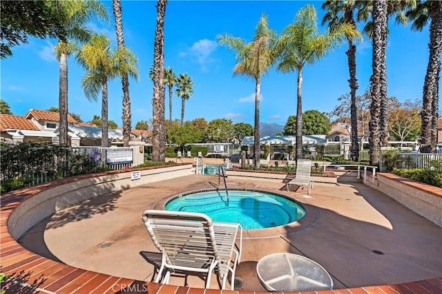 55 Rabano Unit 240, Rancho Santa Margarita, CA 92688 - view of swimming pool featuring a hot tub and a residential view