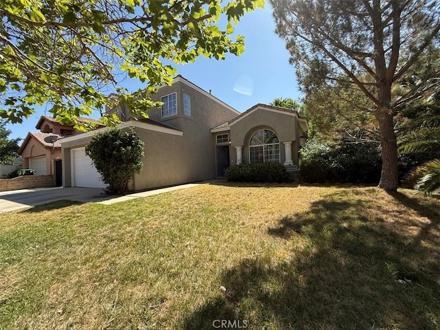42523 56th St W, Lancaster, CA 93536 - view of front facade with stucco siding, driveway, a front lawn, and an attached garage