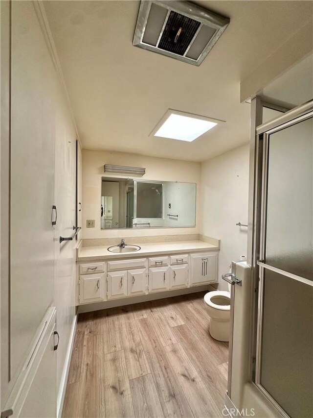 13620 Alderwood Ln Unit 76D, Seal Beach, CA 90740 - bathroom featuring vanity, wood finished floors, and a stall shower