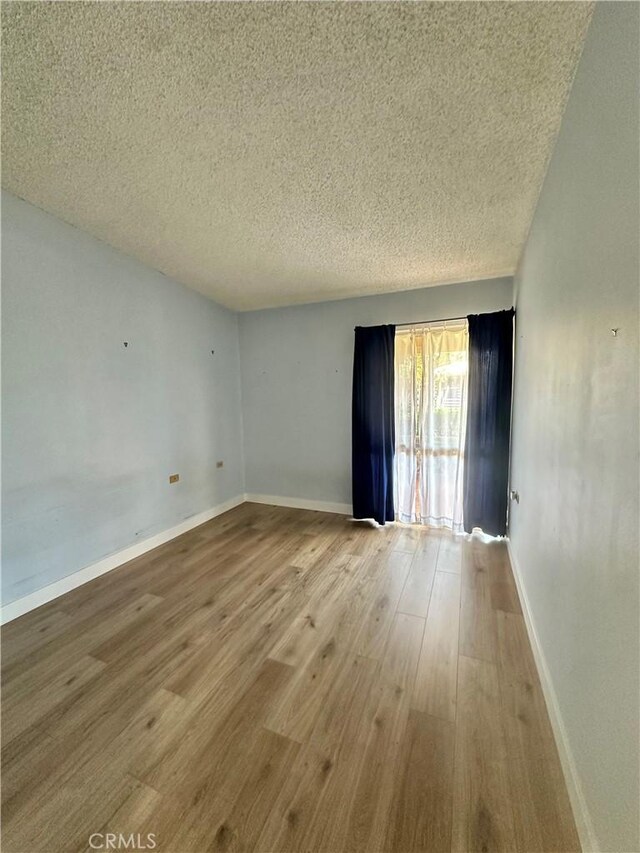 13620 Alderwood Ln Unit 76D, Seal Beach, CA 90740 - unfurnished room featuring a textured ceiling and wood finished floors