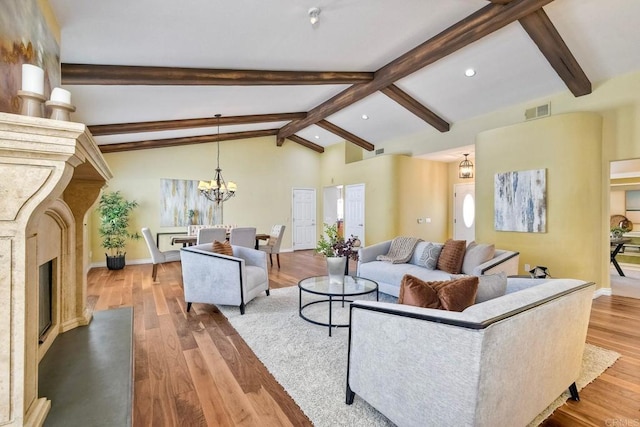 4956 Lamia Way, Oceanside, CA 92056 - living area with a high end fireplace, wood finished floors, recessed lighting, and a chandelier