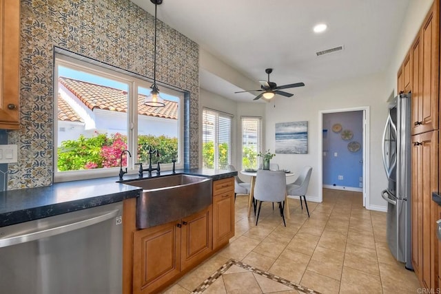 4956 Lamia Way, Oceanside, CA 92056 - kitchen featuring stainless steel appliances, dark countertops, ceiling fan, brown cabinets, and recessed lighting