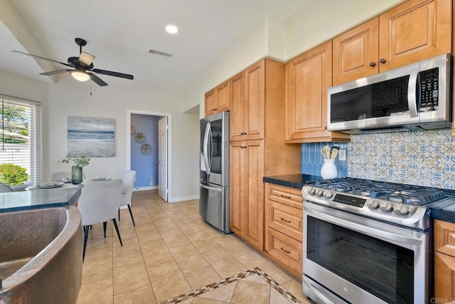4956 Lamia Way, Oceanside, CA 92056 - kitchen with appliances with stainless steel finishes, ceiling fan, backsplash, dark countertops, and light tile patterned floors
