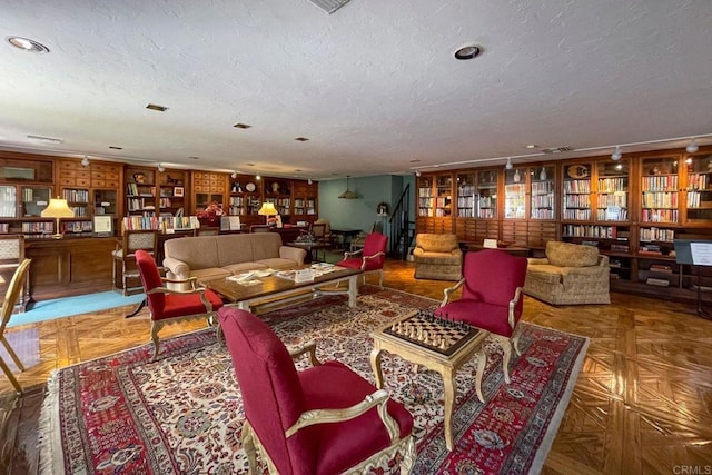 4956 Lamia Way, Oceanside, CA 92056 - living area with a textured ceiling, recessed lighting, and wall of books