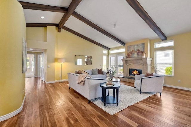 4956 Lamia Way, Oceanside, CA 92056 - living room with beam ceiling, wood-type flooring, healthy amount of natural light, a glass covered fireplace, and high vaulted ceiling