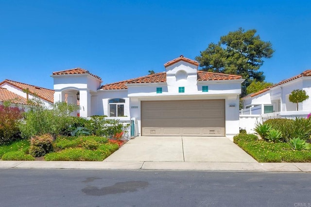 4956 Lamia Way, Oceanside, CA 92056 - mediterranean / spanish home featuring a tile roof, stucco siding, driveway, and a garage