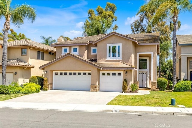 18 Argento, Mission Viejo, CA 92692 - view of front of house featuring stucco siding, stone siding, concrete driveway, a front yard, and a tile roof