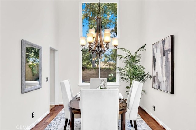 18 Argento, Mission Viejo, CA 92692 - dining area featuring a chandelier, dark wood-style flooring, and a towering ceiling