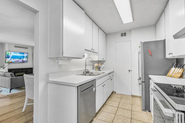 4833 Collwood Blvd Unit A, San Diego, CA 92115 - kitchen with dishwasher, light countertops, white cabinets, stove, and open floor plan