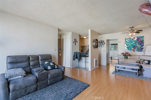 820 N Raymond Ave, Pasadena, CA 91103 - living room with a ceiling fan, light wood finished floors, and a textured ceiling