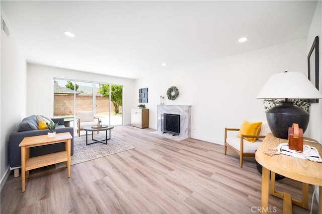 1019 E Armstead St, Azusa, CA 91702 - living area featuring wood finished floors, a premium fireplace, and recessed lighting