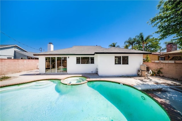 1019 E Armstead St, Azusa, CA 91702 - back of property with a patio, a fenced backyard, stucco siding, and a pool with connected hot tub