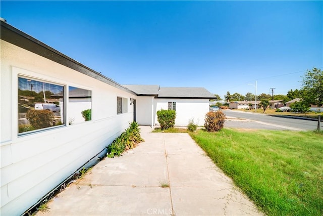 1019 E Armstead St, Azusa, CA 91702 - view of side of property featuring a lawn and a patio