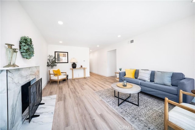 1019 E Armstead St, Azusa, CA 91702 - living room featuring light wood-style flooring, recessed lighting, and a fireplace