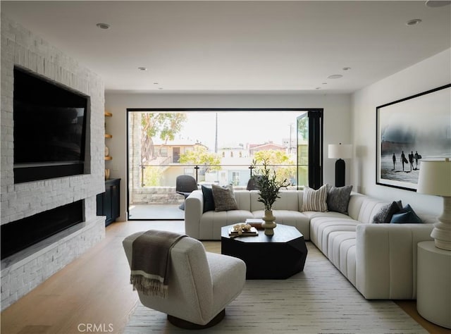 1313 Ocean Ave, Seal Beach, CA 90740 - living area with healthy amount of natural light, a large fireplace, wood finished floors, and recessed lighting