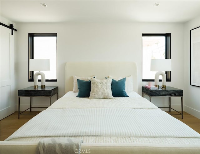 1313 Ocean Ave, Seal Beach, CA 90740 - bedroom featuring a barn door, wood finished floors, and recessed lighting