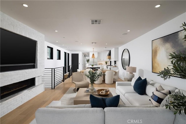 1315 Ocean Ave, Seal Beach, CA 90740 - living room featuring recessed lighting, light wood finished floors, and a fireplace