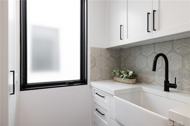 1315 Ocean Ave, Seal Beach, CA 90740 - kitchen featuring white cabinets, tasteful backsplash, and light countertops